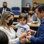 Brazilian family at kitchen table with tax documents during imposto de renda 2026 season